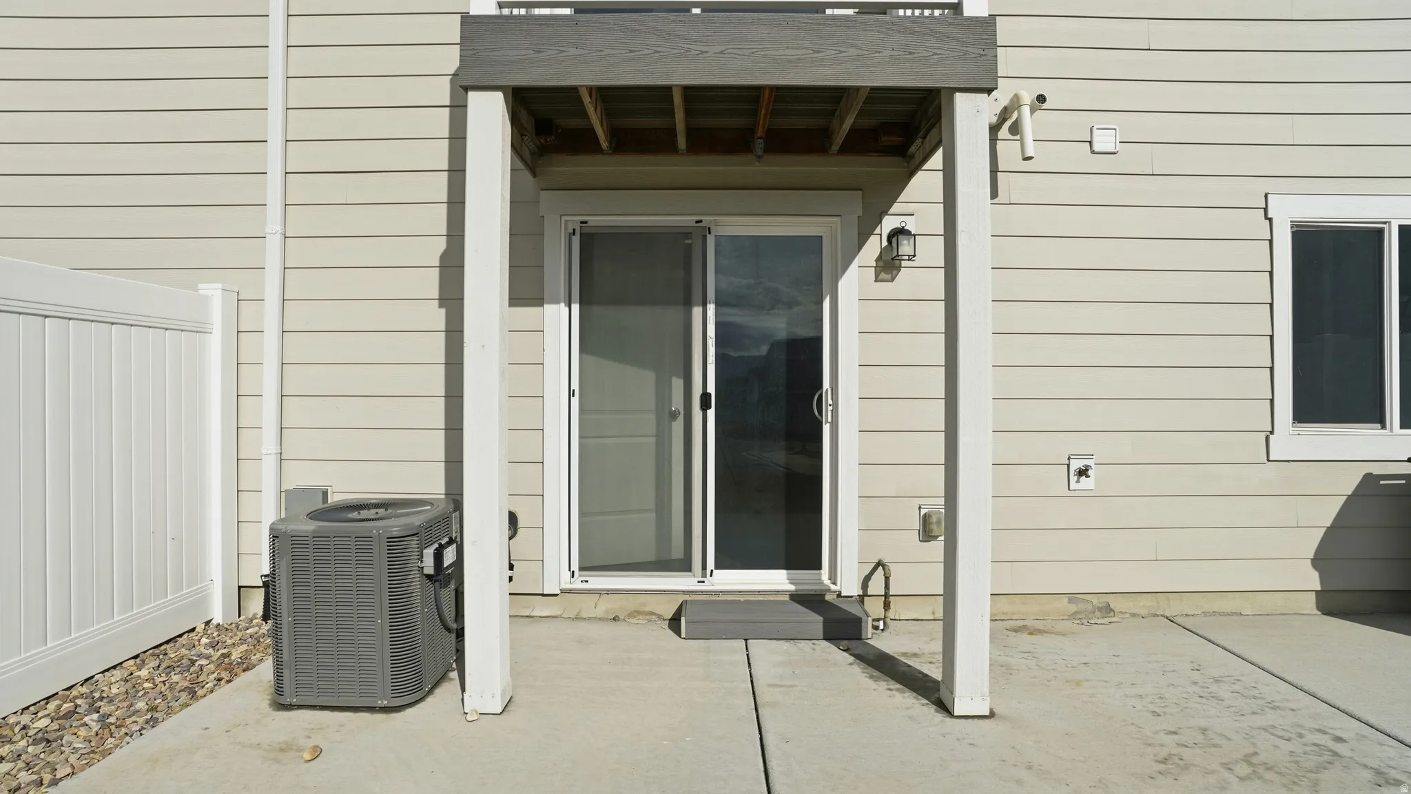View of exterior entry with a patio