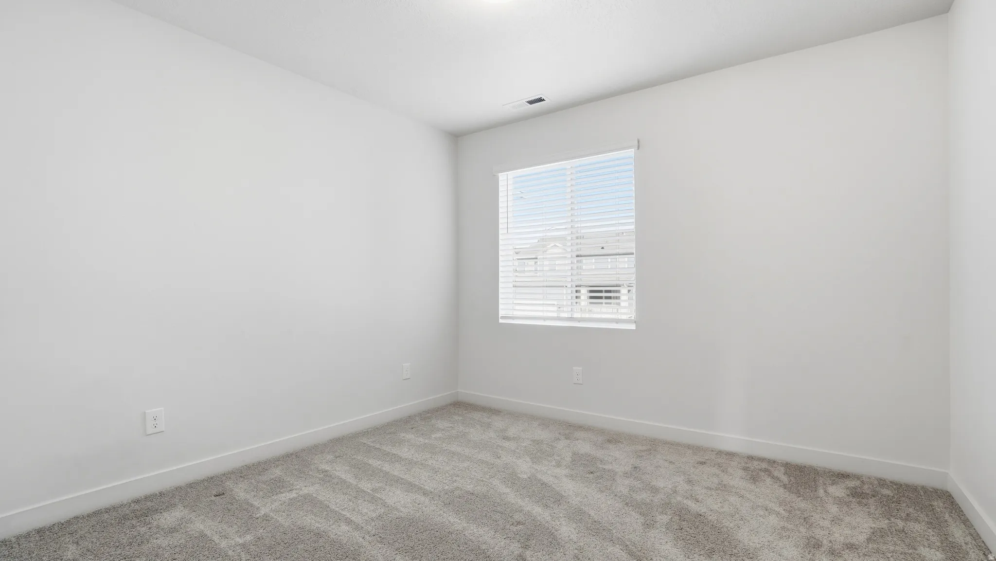 Unfurnished room with baseboards and carpet