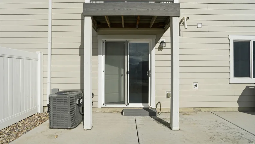 View of exterior entry with a patio