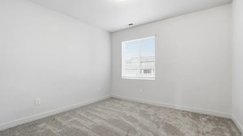Unfurnished room with baseboards and carpet