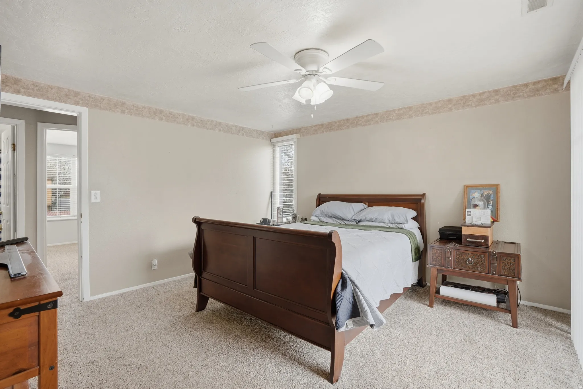 Bedroom with light carpet and ceiling fan