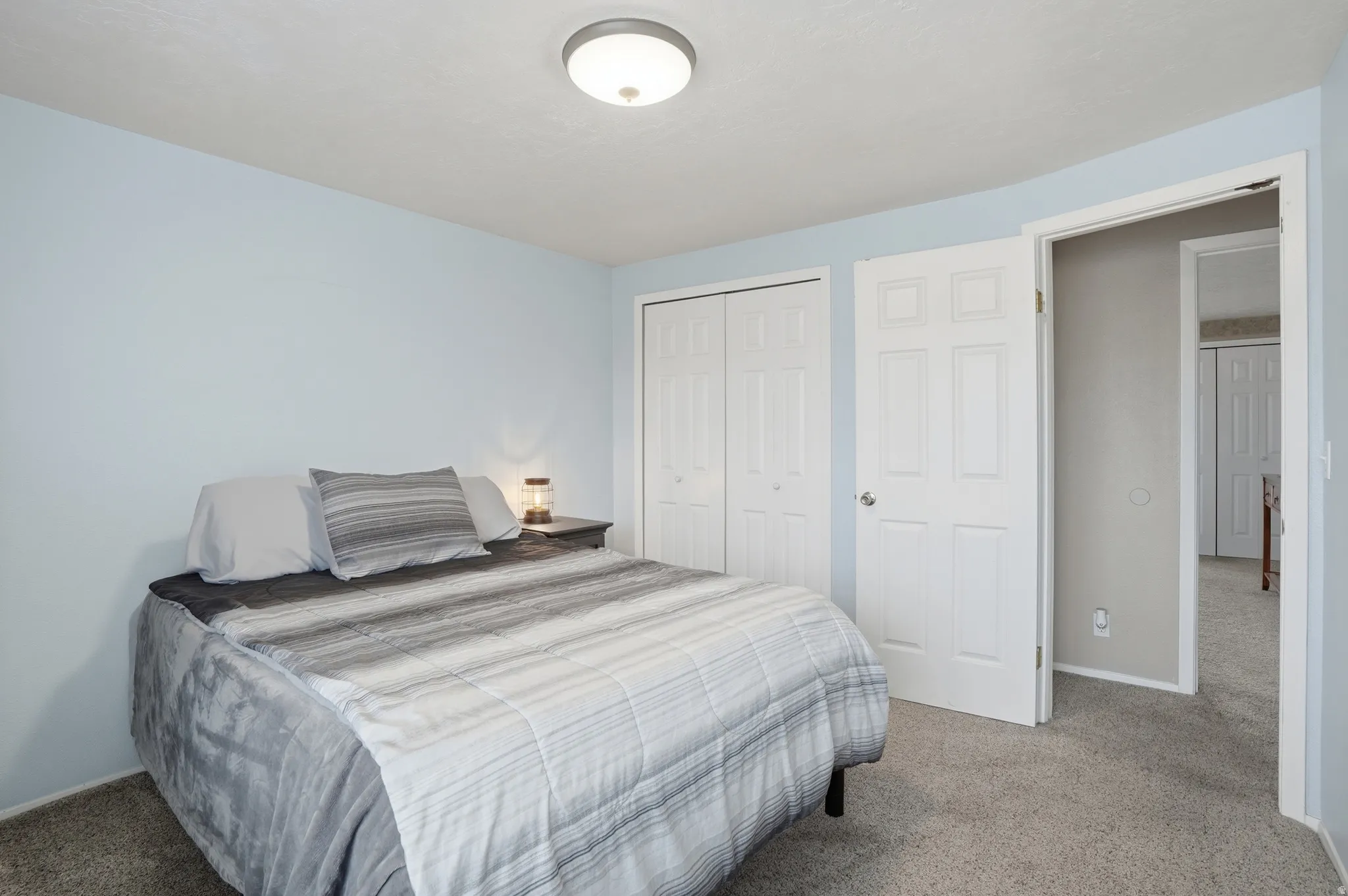 Carpeted bedroom featuring a closet and baseboards