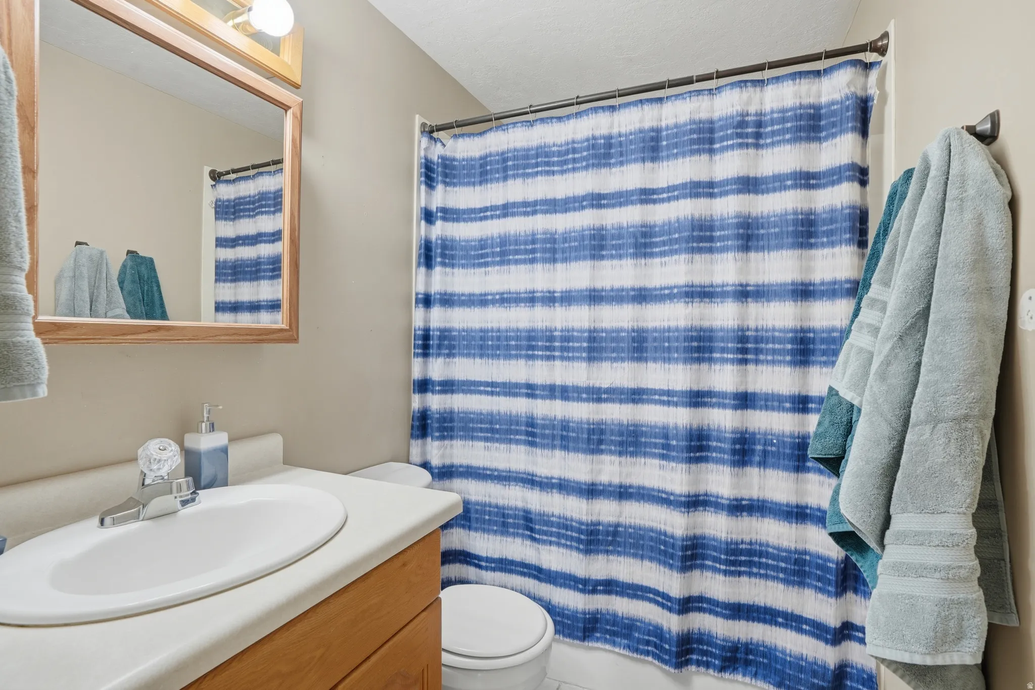 Bathroom featuring vanity and shower / bath combo