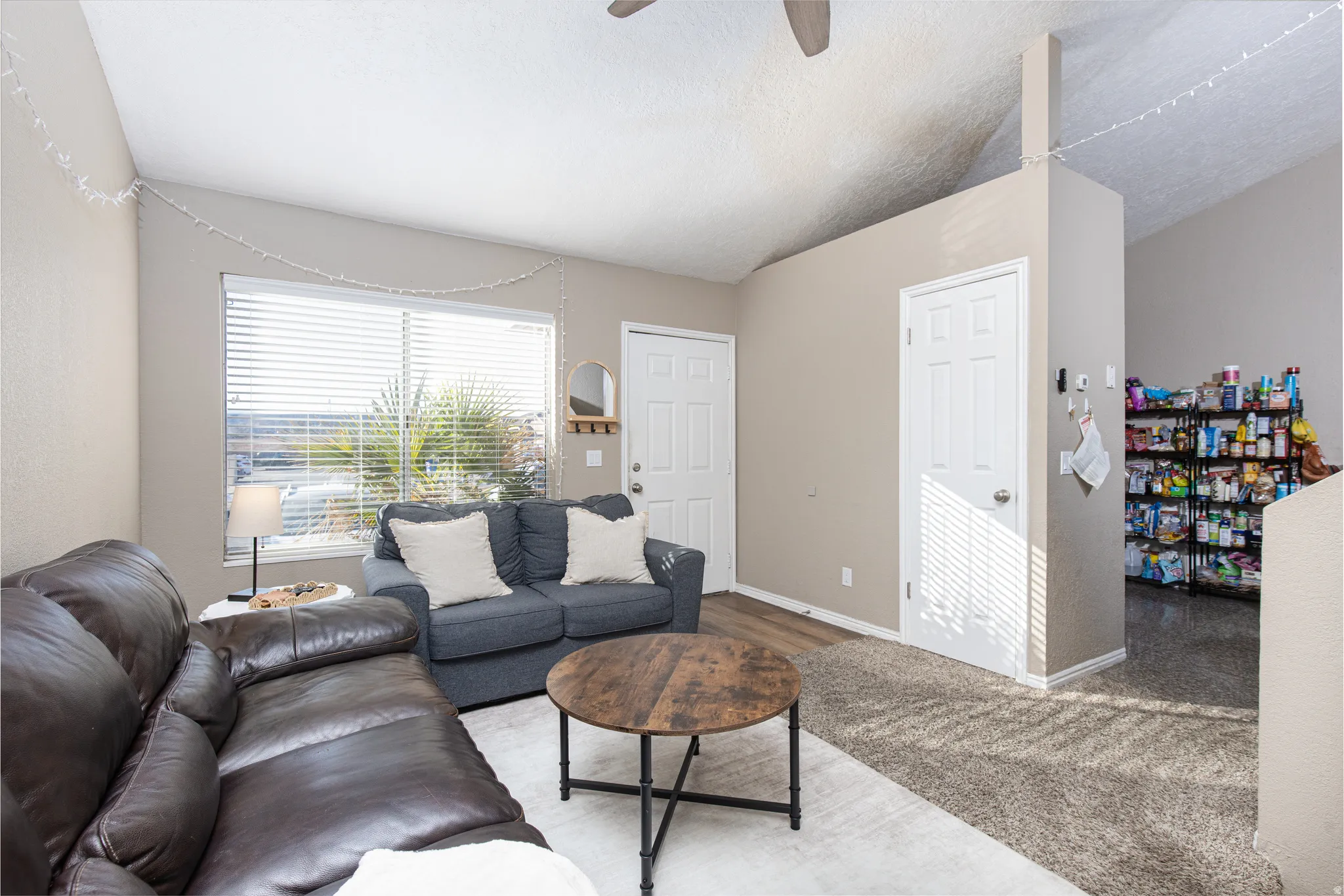 Living room with a ceiling fan and baseboards