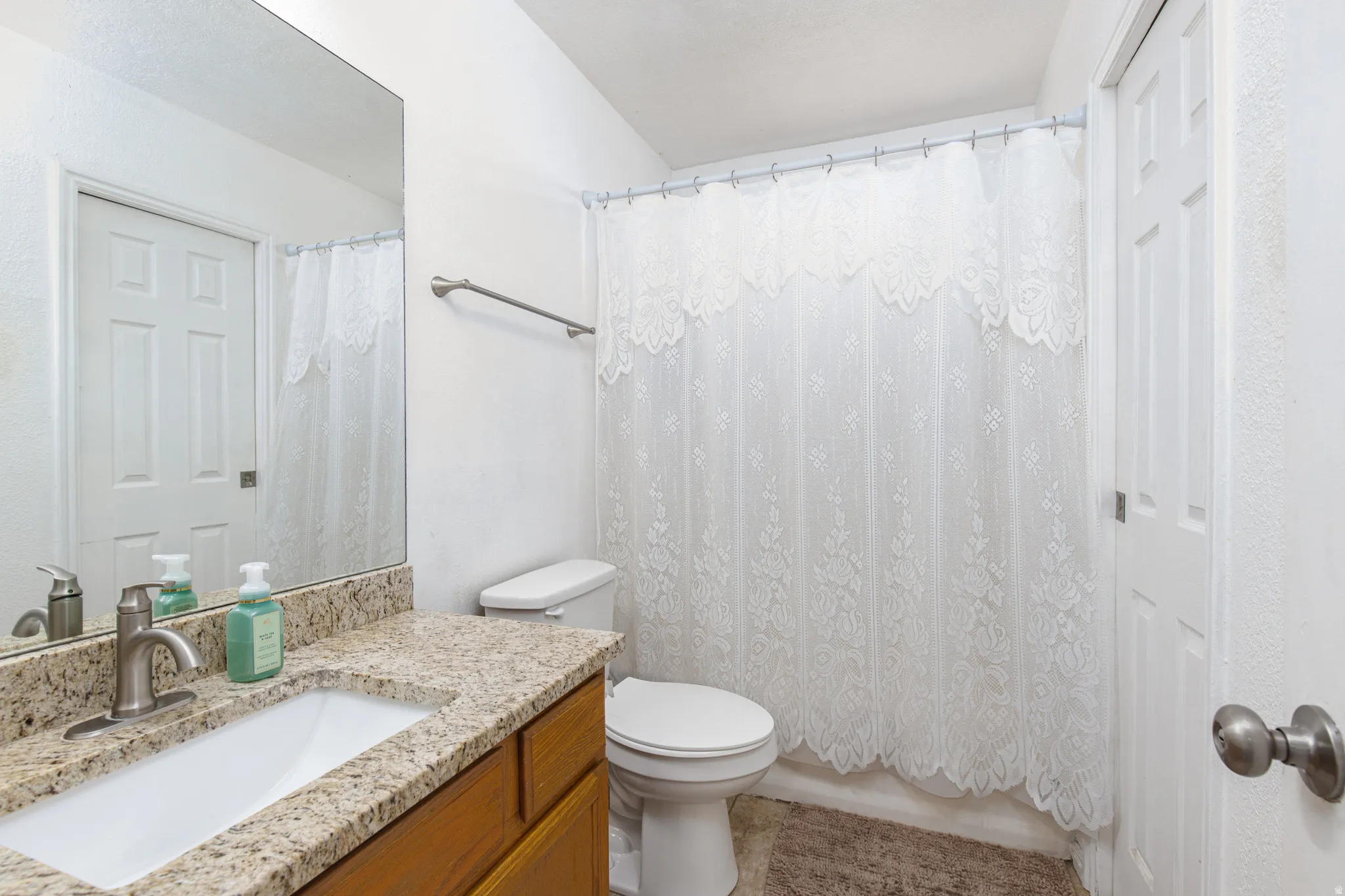 Full bathroom with vanity and shower / bath combination with curtain