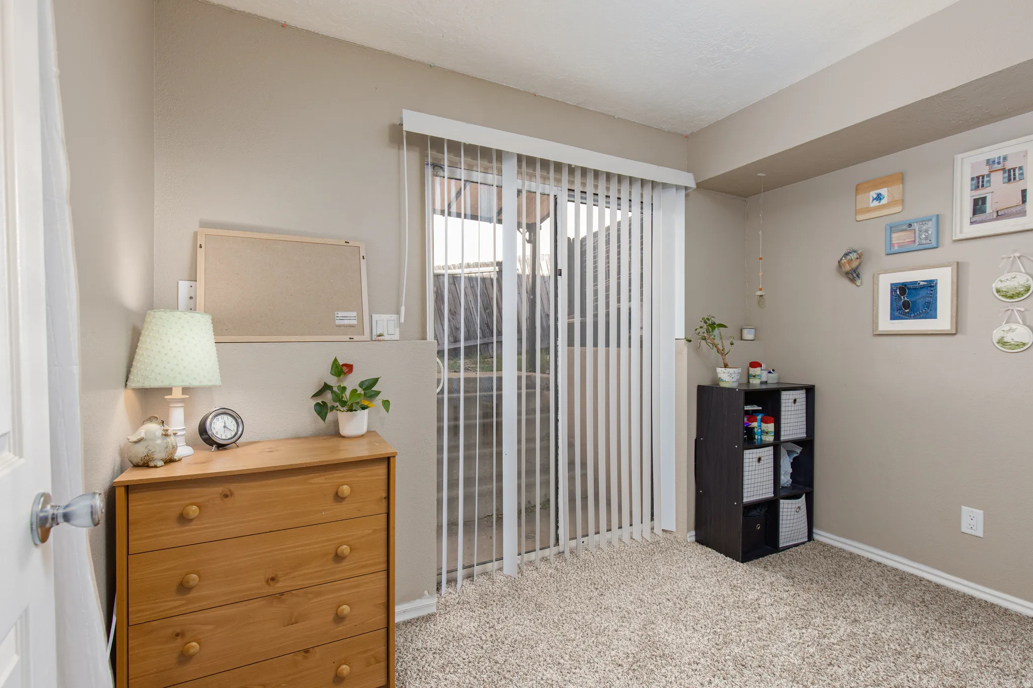 Bedroom with light carpet and baseboards