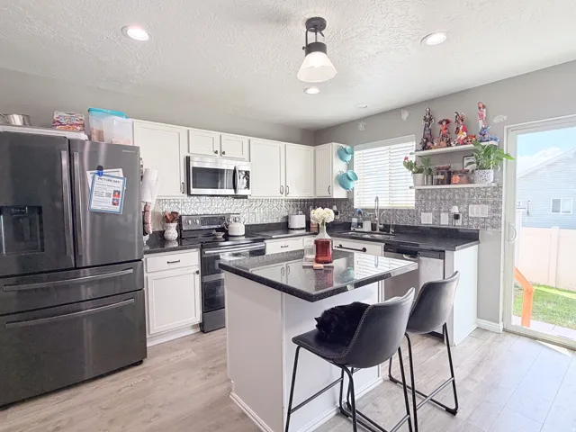 White cabinetry and dark countertops