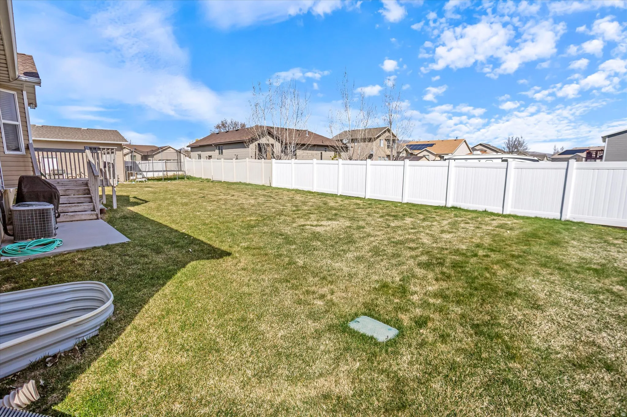 Fenced backyard featuring a residential view and a patio