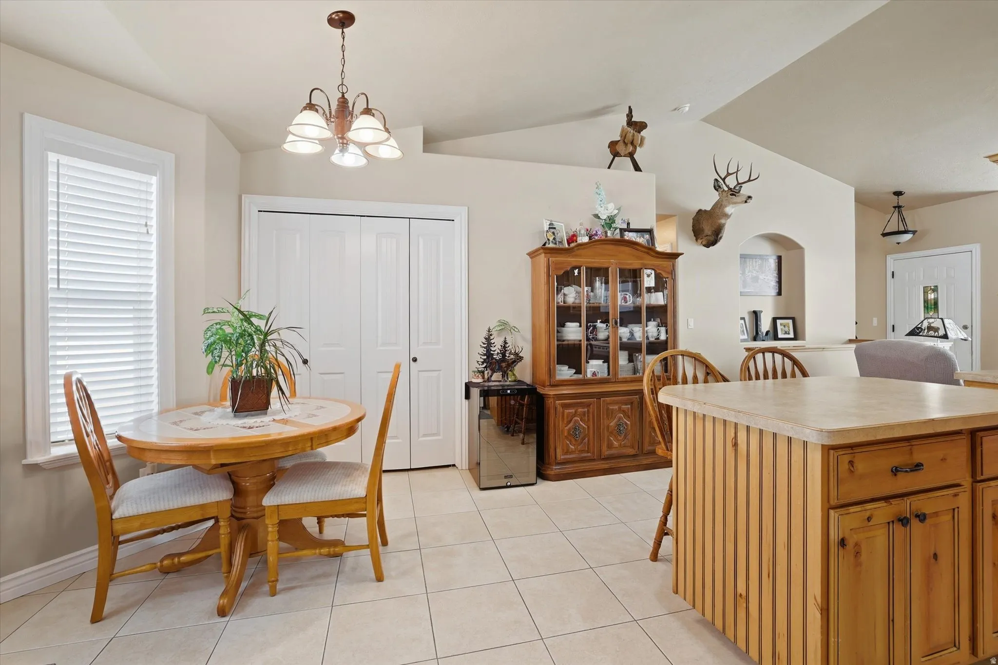 Dining room featuring suspended lighting, light tile patterned floors, and plenty of natural light