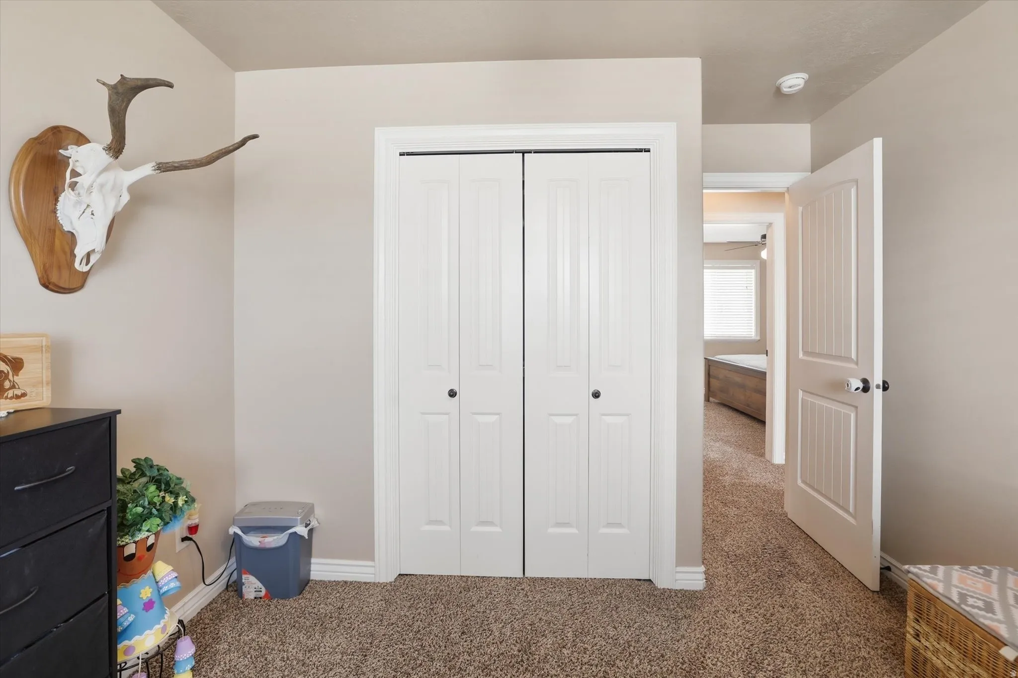 Bedroom featuring carpet flooring and a closet