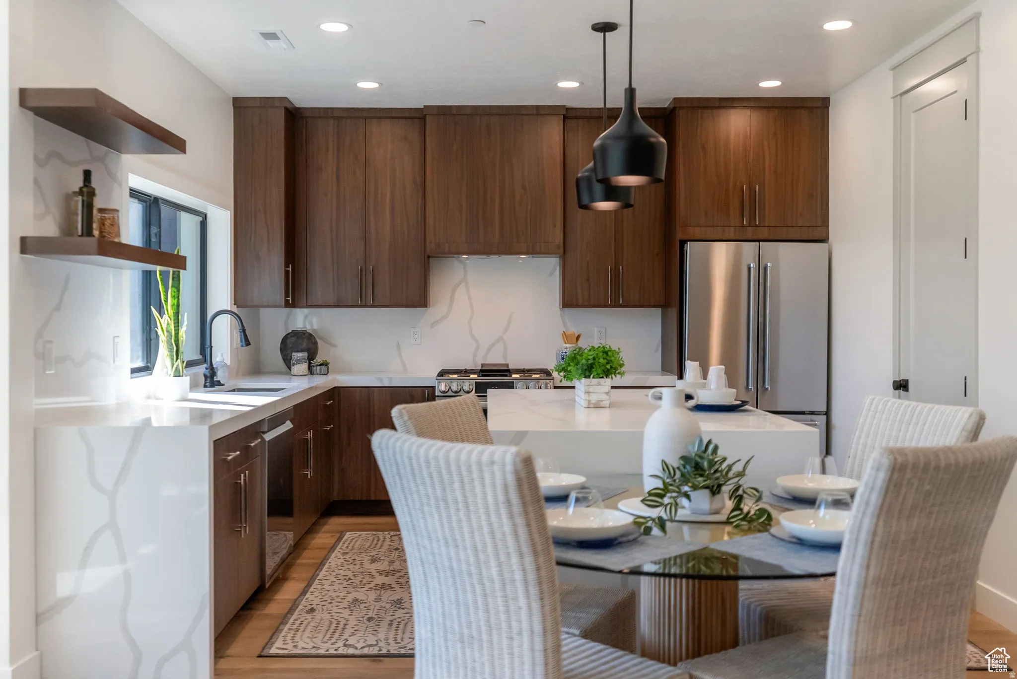 Kitchen with open shelves, light stone countertops, decorative light fixtures, and modern cabinets