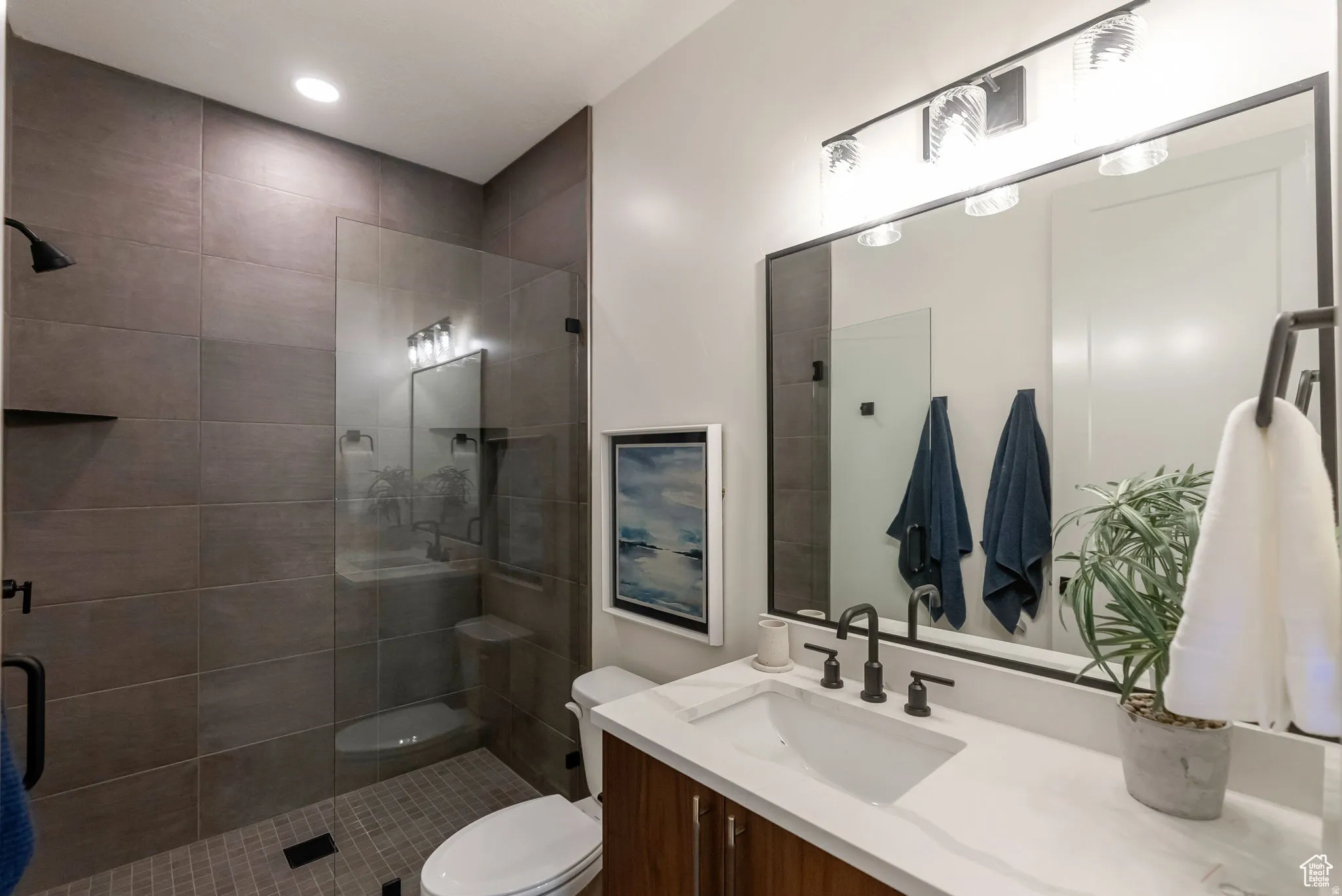 Full bath featuring vanity, a stall shower, and recessed lighting