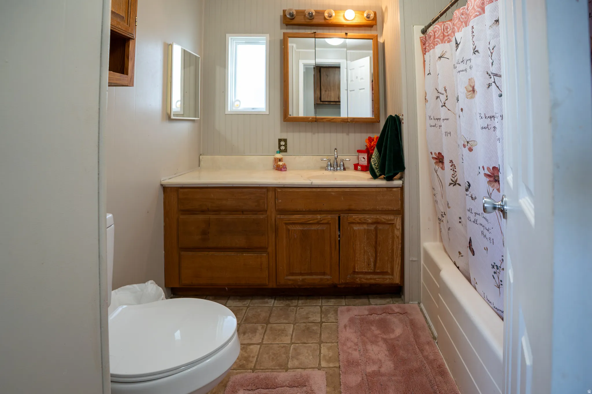 Bathroom featuring vanity and shower / bath combo