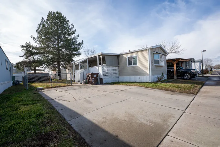 View of property exterior with concrete driveway