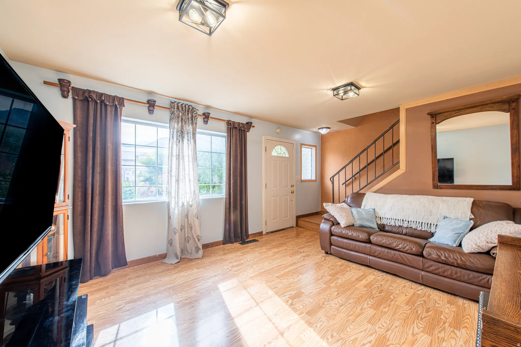 Living area with stairs and light wood-type flooring