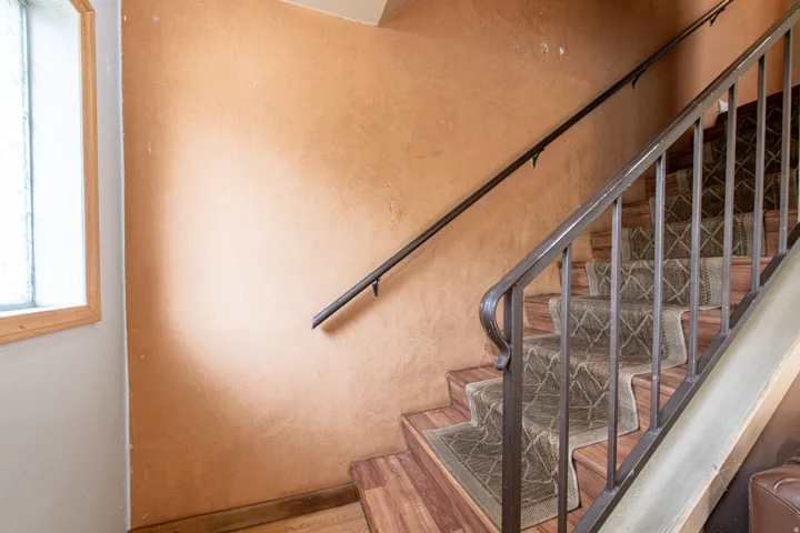 Staircase featuring wood finished floors