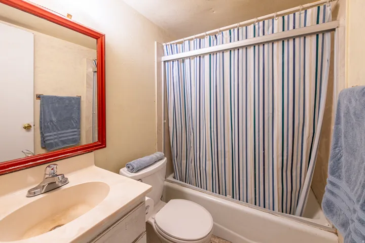 Full bathroom with vanity and shower / bath combination with curtain