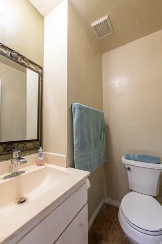 Half bath featuring vanity and toilet