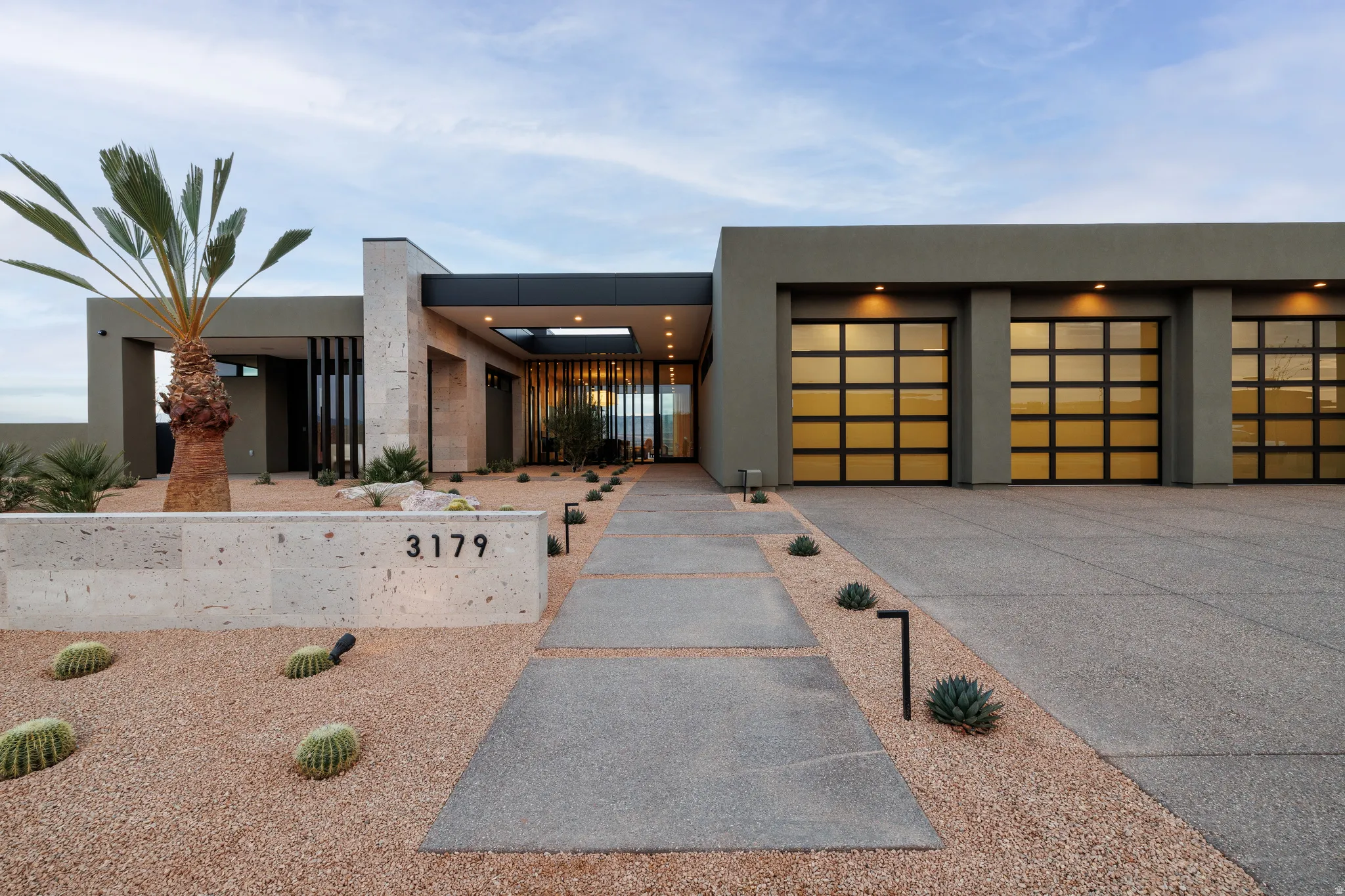 Three 10'x10' Garage Doors, Volcanic Stone, and Metal Accents on the Exterior