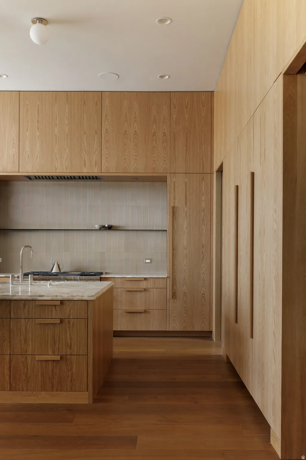 Custom Wood Paneling, Signature Oversized Refrigerator and Gas Stove