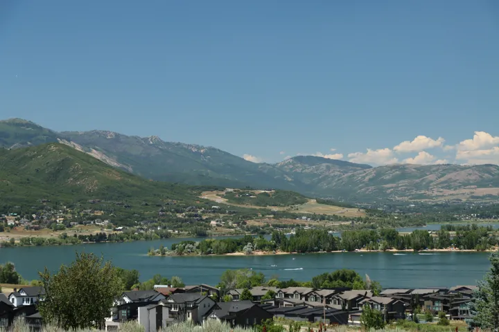 Water view featuring mountains and nearby suburban area