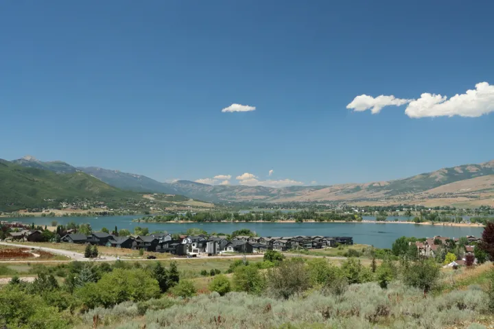 Mountain view featuring a large body of water and nearby suburban area