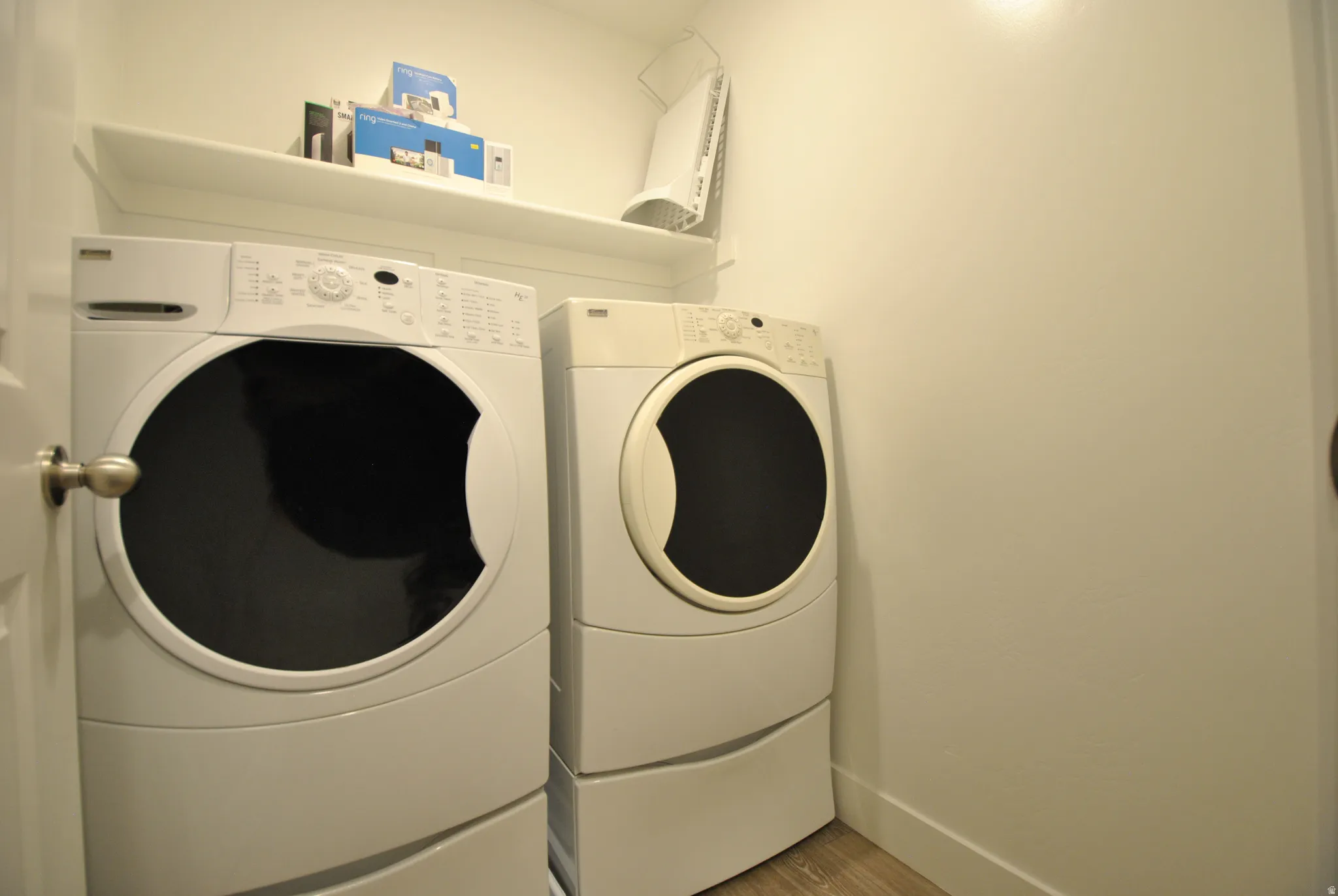 Laundry room featuring washing machine and clothes dryer and wood finished floors