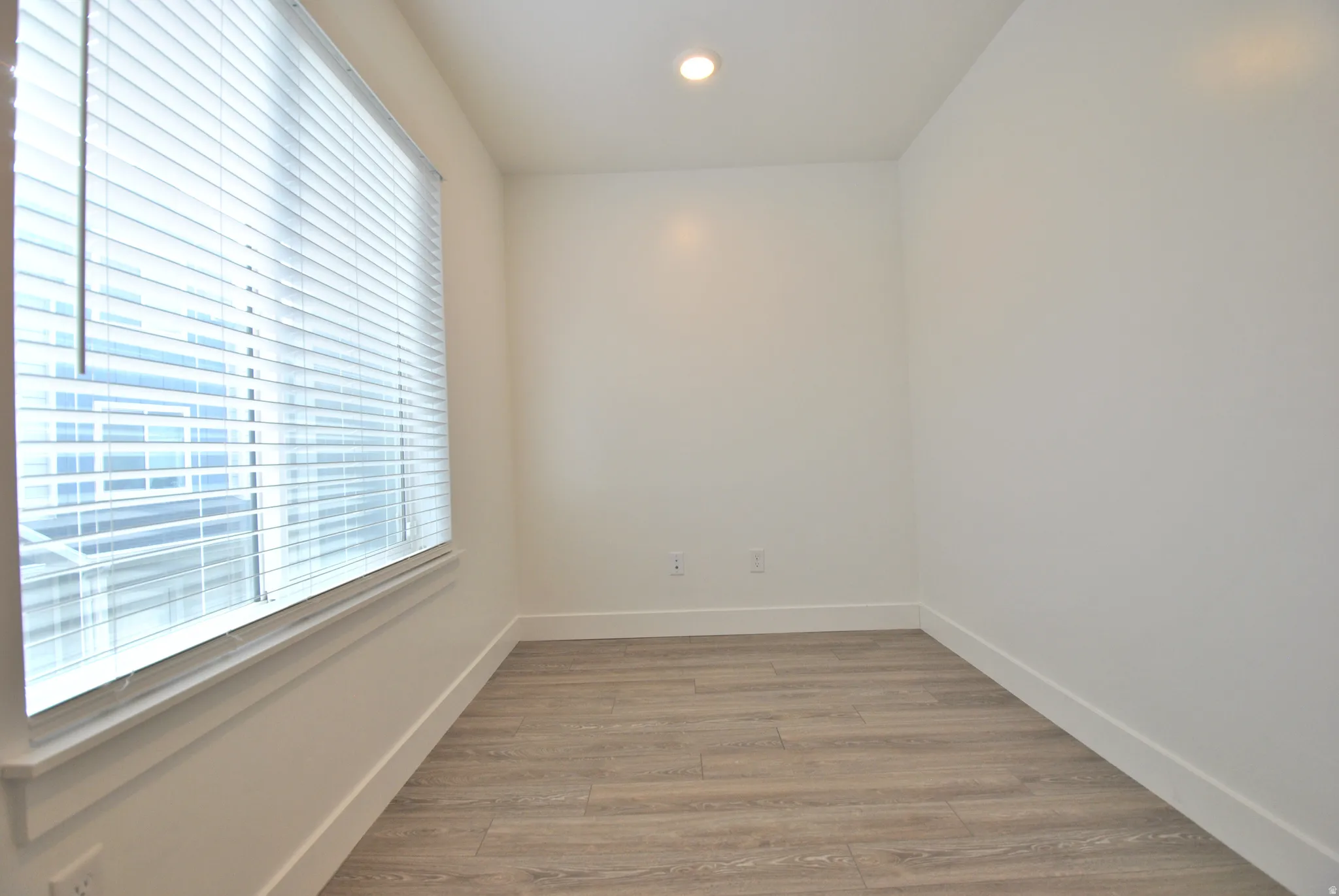 Office nook featuring light wood finished floors and recessed lighting
