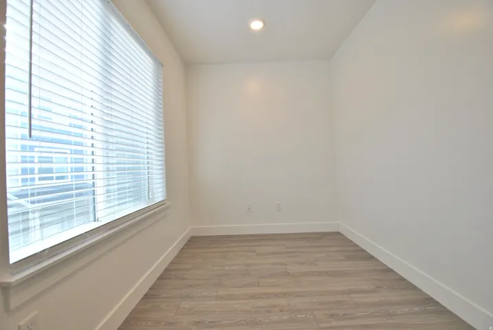 Office nook featuring light wood finished floors and recessed lighting