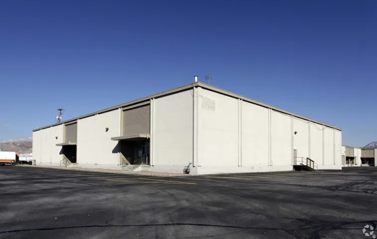 View of building exterior with uncovered parking