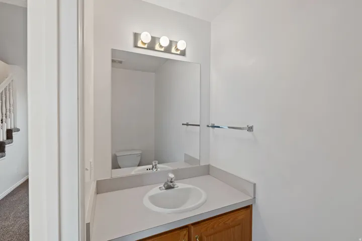 Half bathroom with vanity and toilet