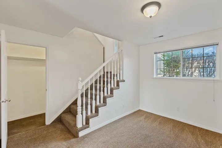 Stairway with carpet floors, large Storage available underneath stair risers.