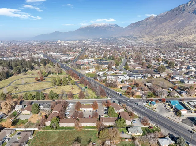 Aerial overview of property's location featuring nearby suburban area and a mountainous background