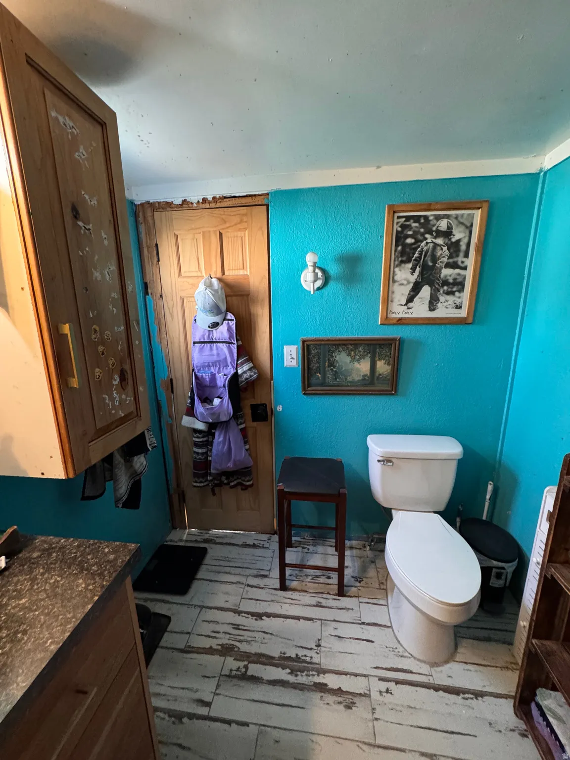 Bathroom featuring vanity, light wood-style floors, and a textured wall