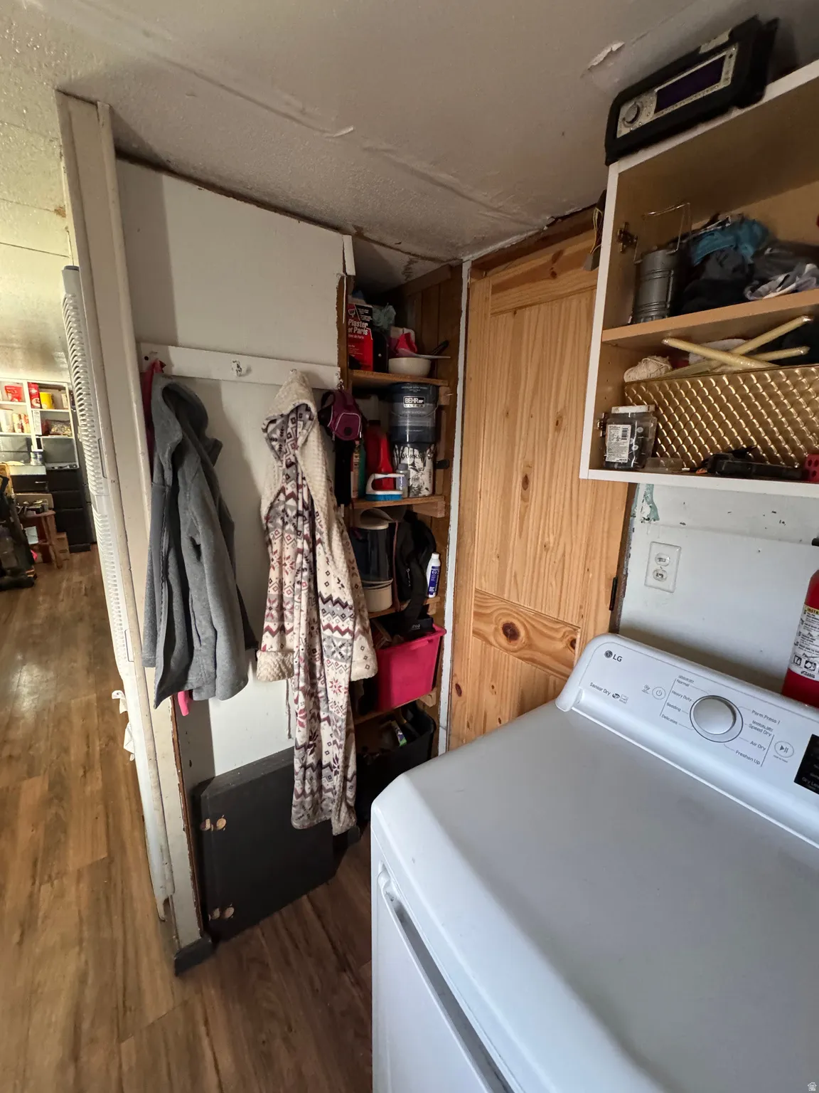 Laundry room with washer / dryer and dark wood-style flooring