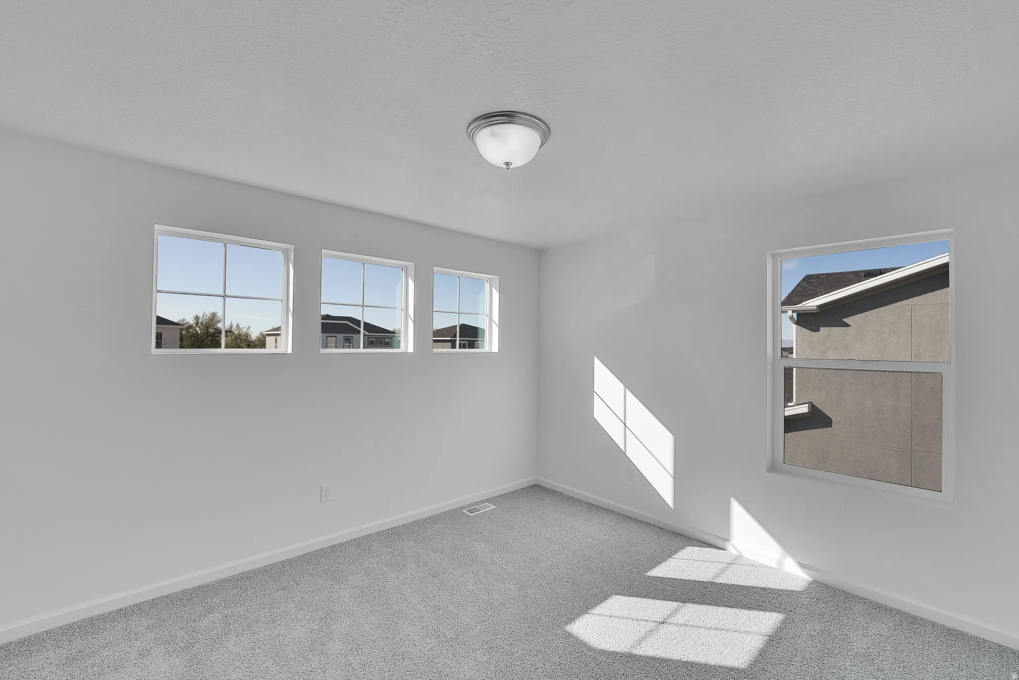 Unfurnished room featuring baseboards and light colored carpet