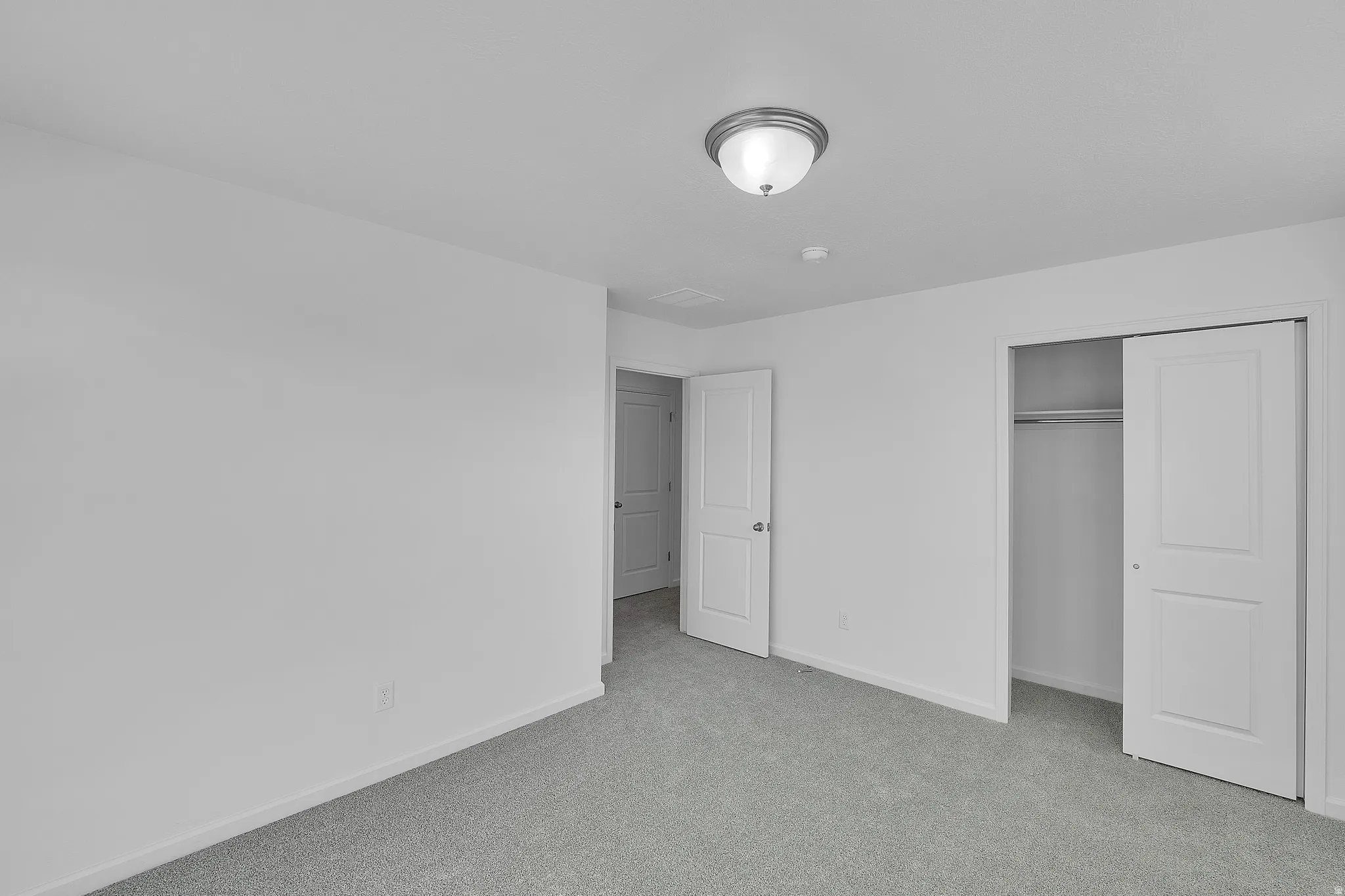 Unfurnished bedroom with carpet flooring and a closet