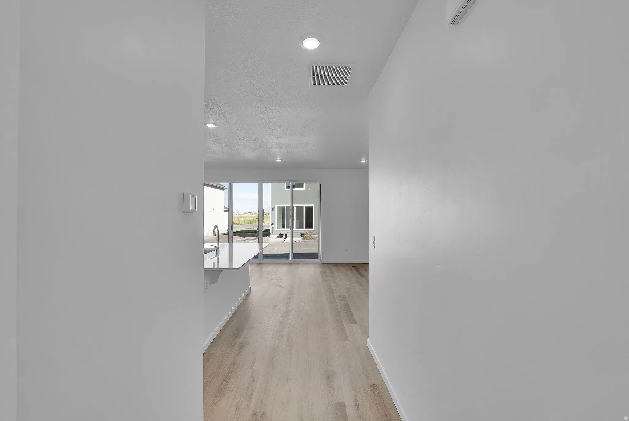 Hallway with recessed lighting and light wood finished floors