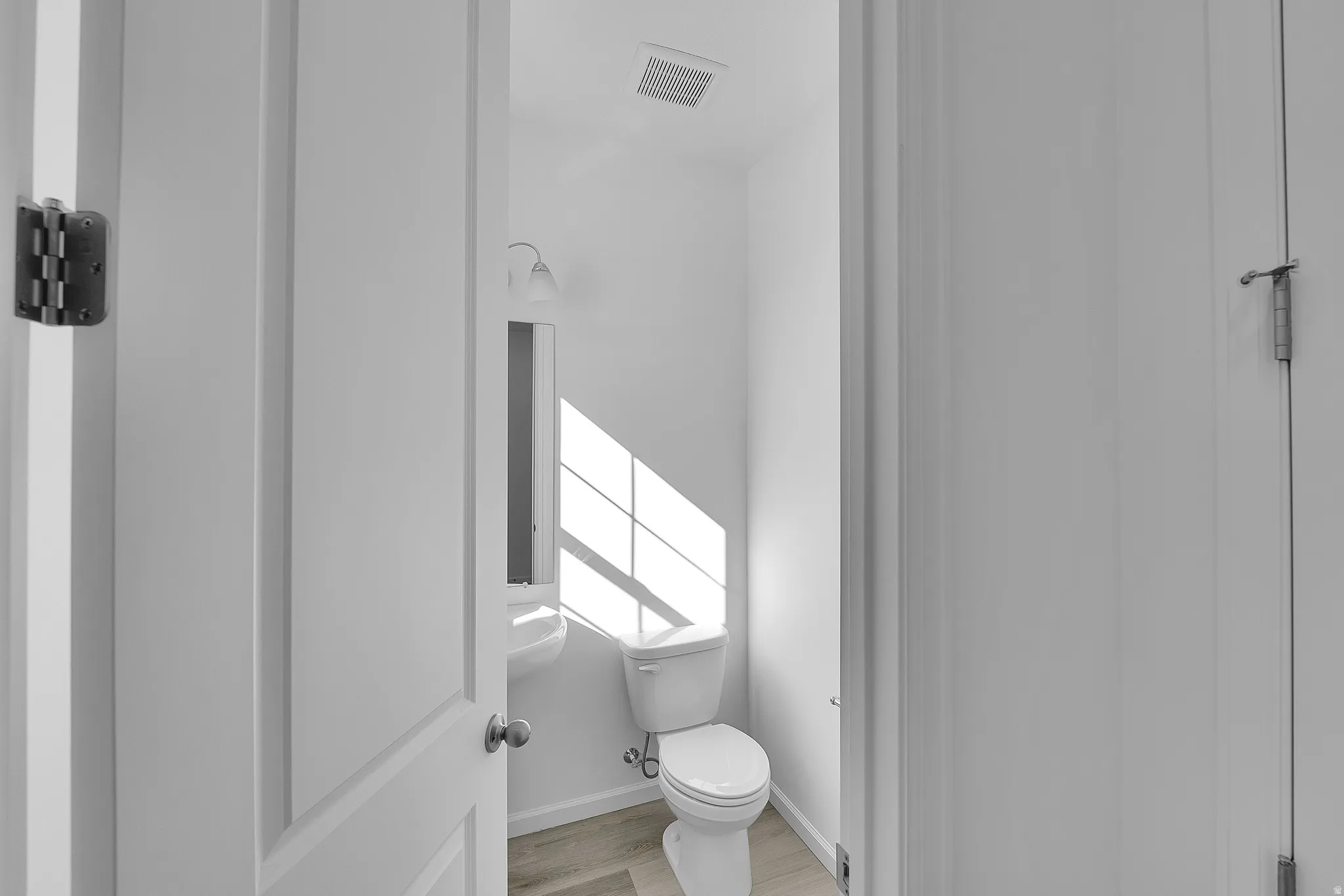 Bathroom featuring toilet and light wood-type flooring