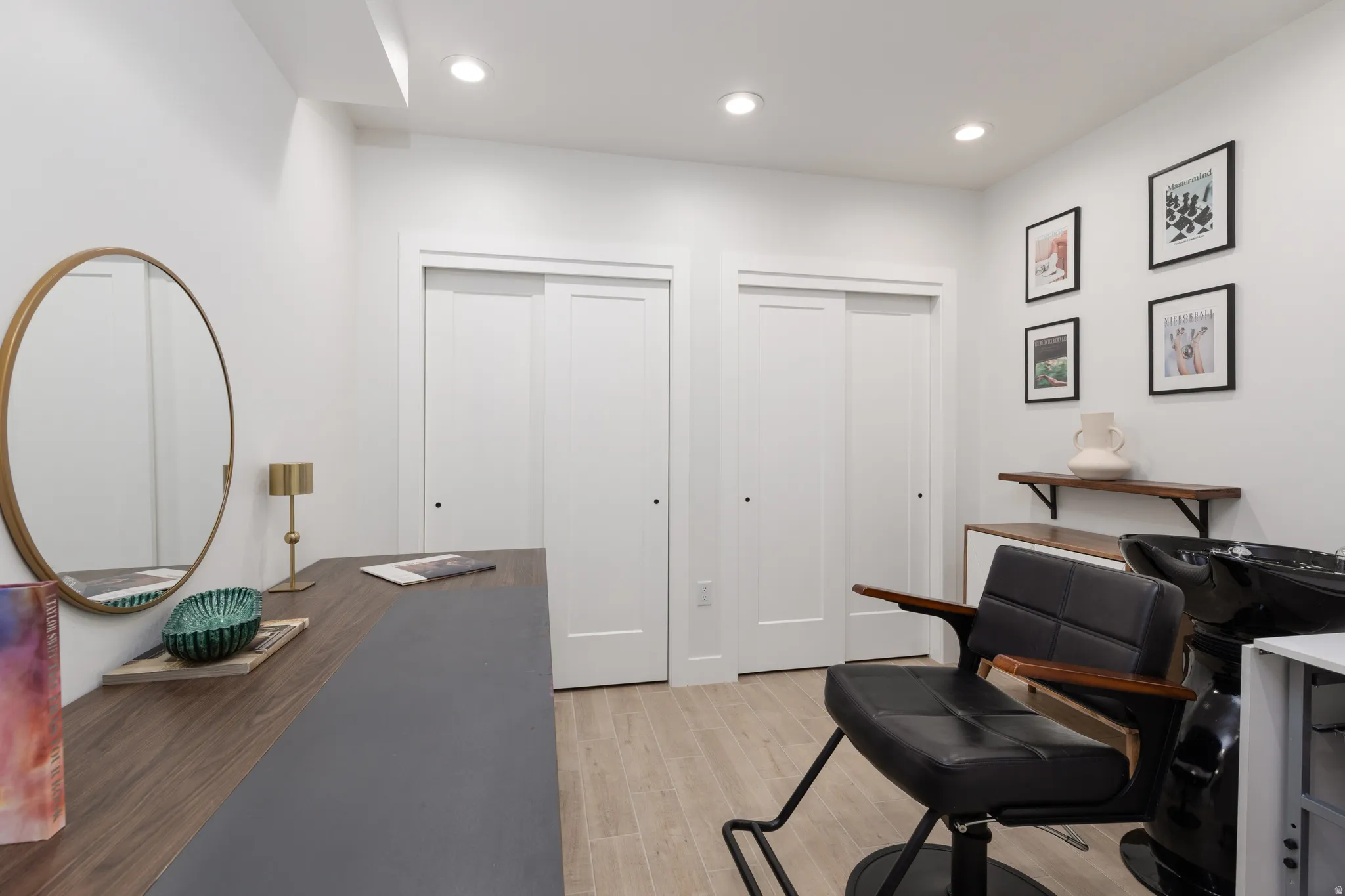 Work area with light wood finished floors and recessed lighting for salon