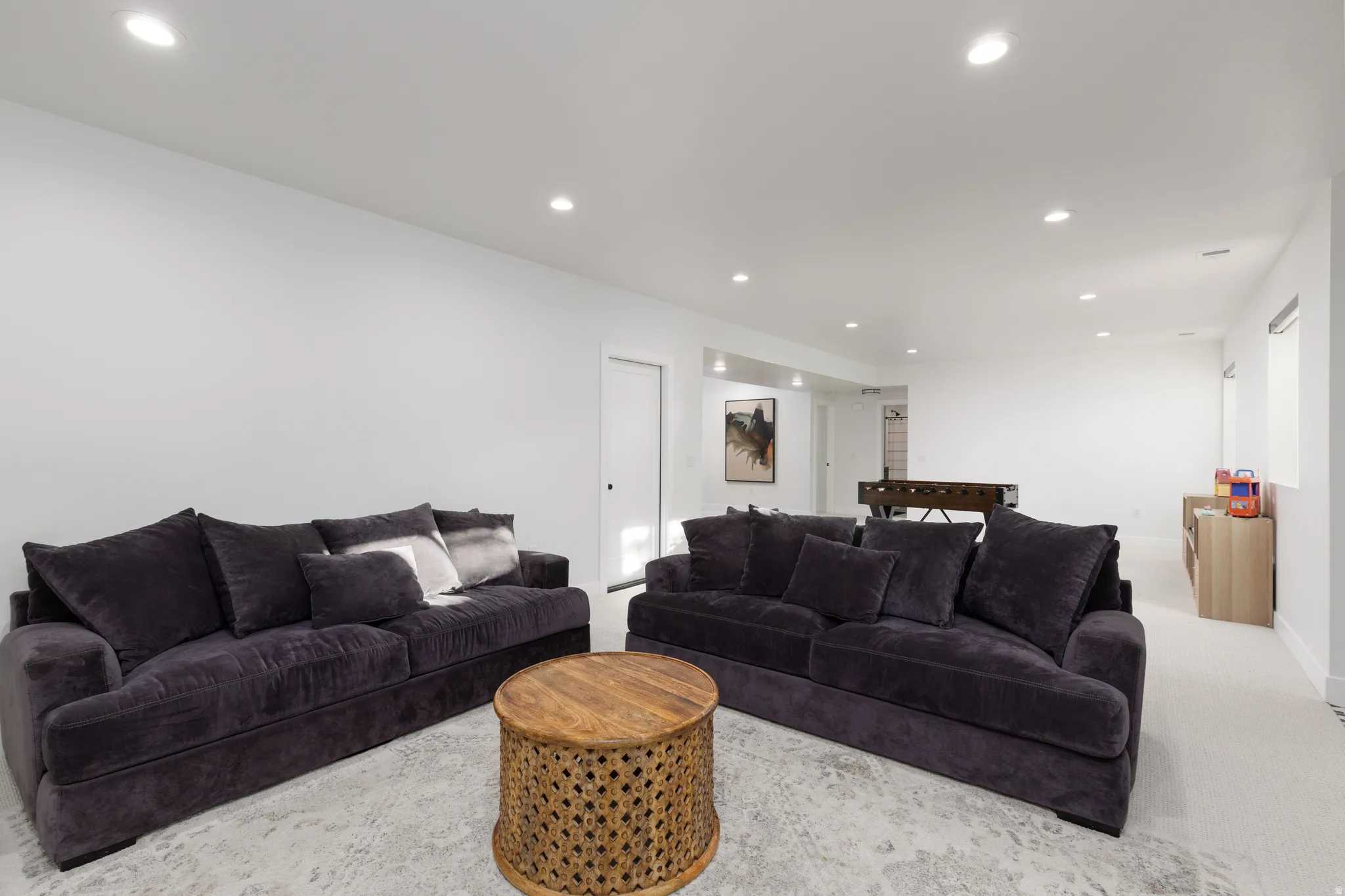 Carpeted living room featuring recessed lighting and baseboards
