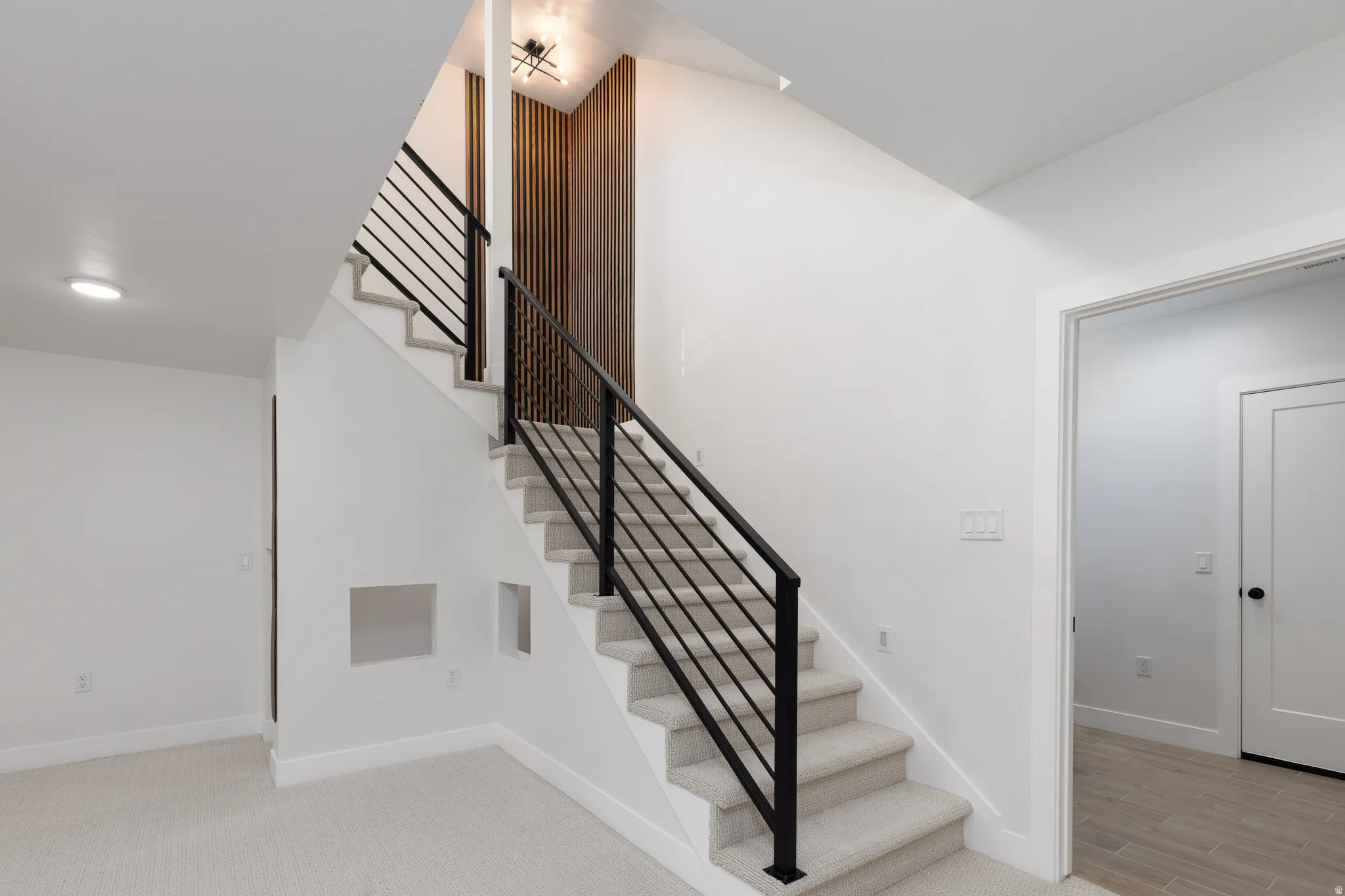 Staircase featuring baseboards and carpet floors