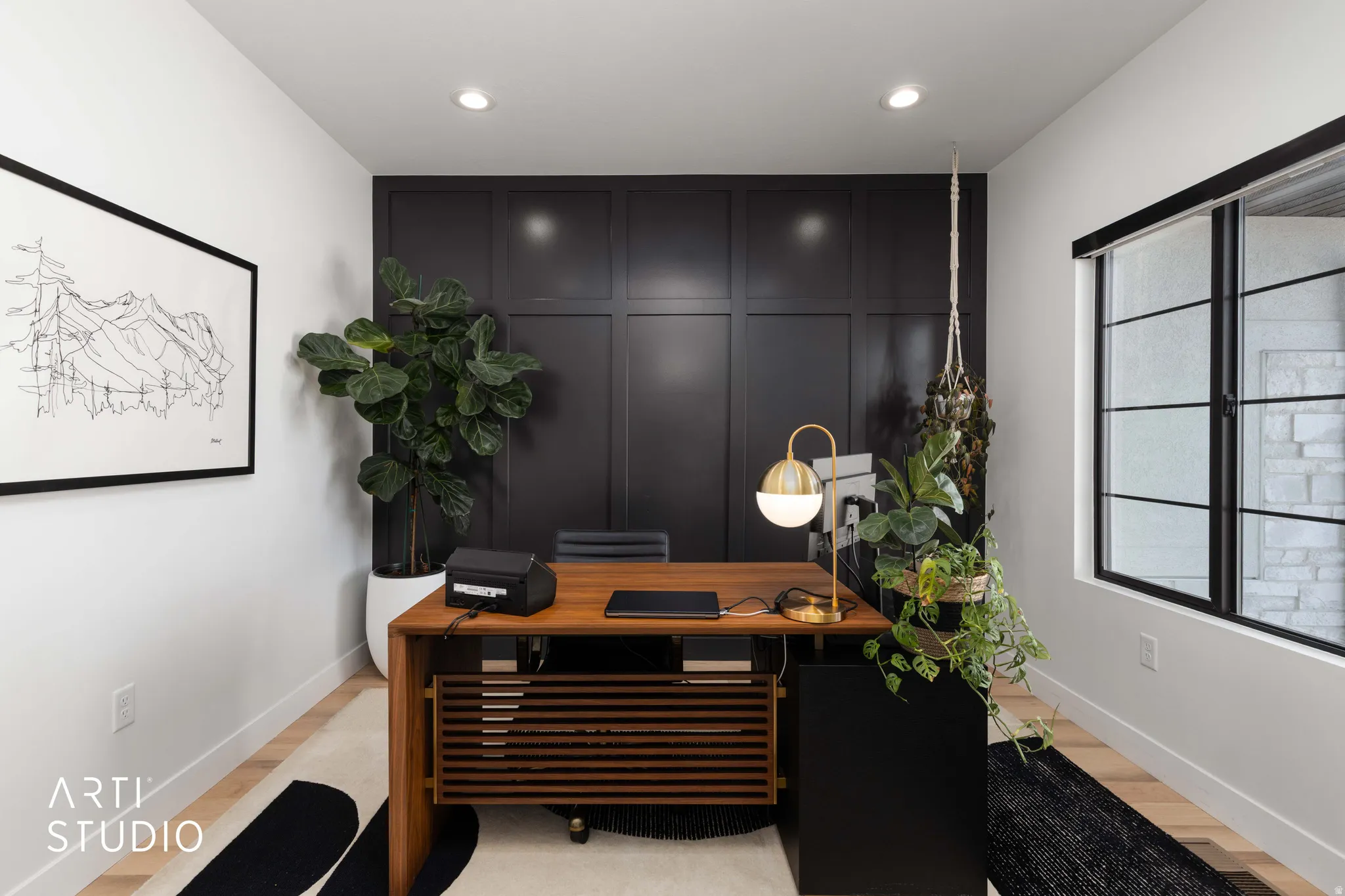 Home office with an accent wall, light wood-type flooring, a decorative wall, and recessed lighting