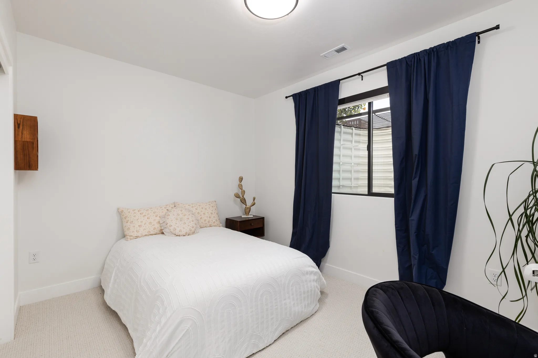 Carpeted bedroom featuring baseboards
