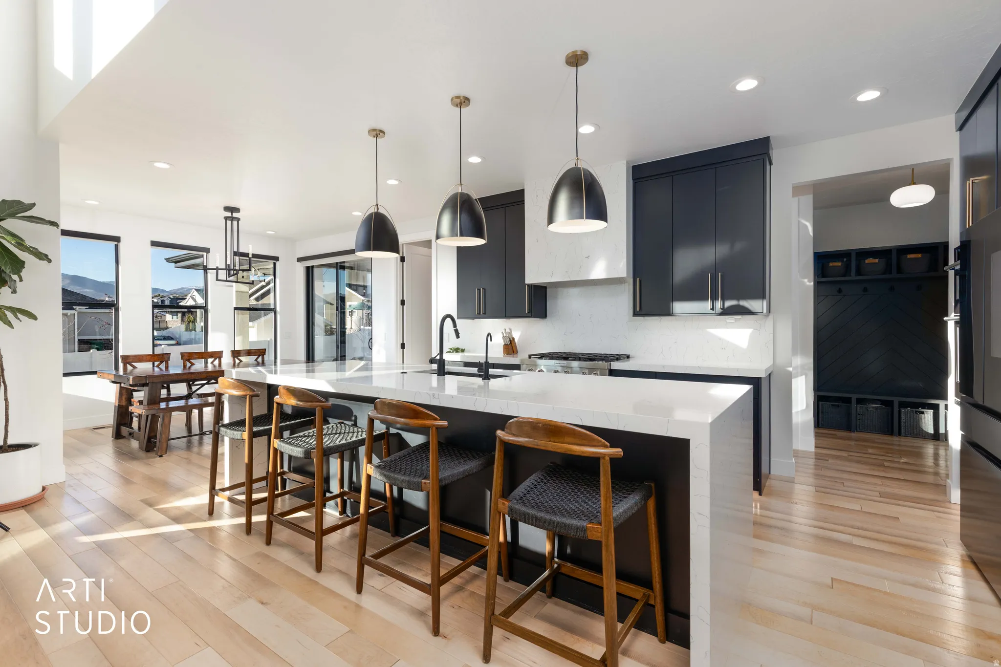 Kitchen with decorative light fixtures, a kitchen breakfast bar, recessed lighting, and light stone counters