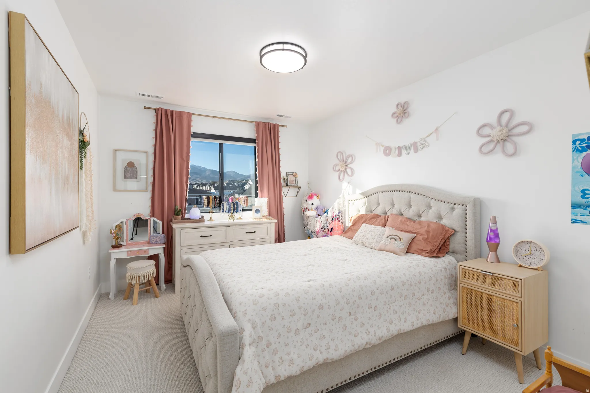 Carpeted bedroom featuring baseboards and a mountain view
