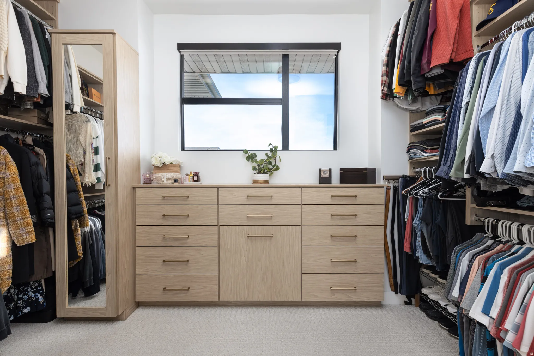 Spacious closet featuring light colored carpet