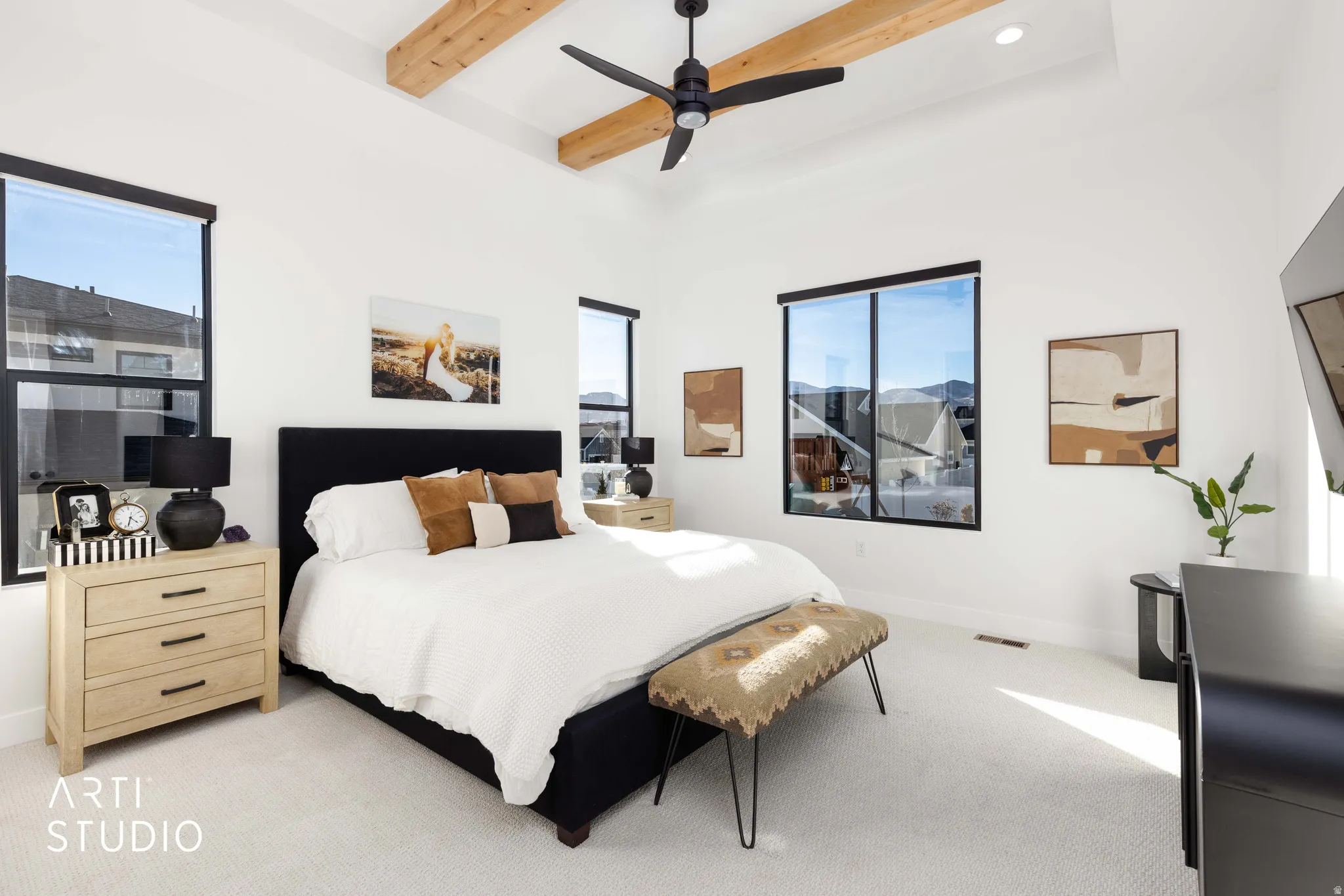 Bedroom with beam ceiling, a ceiling fan, and carpet