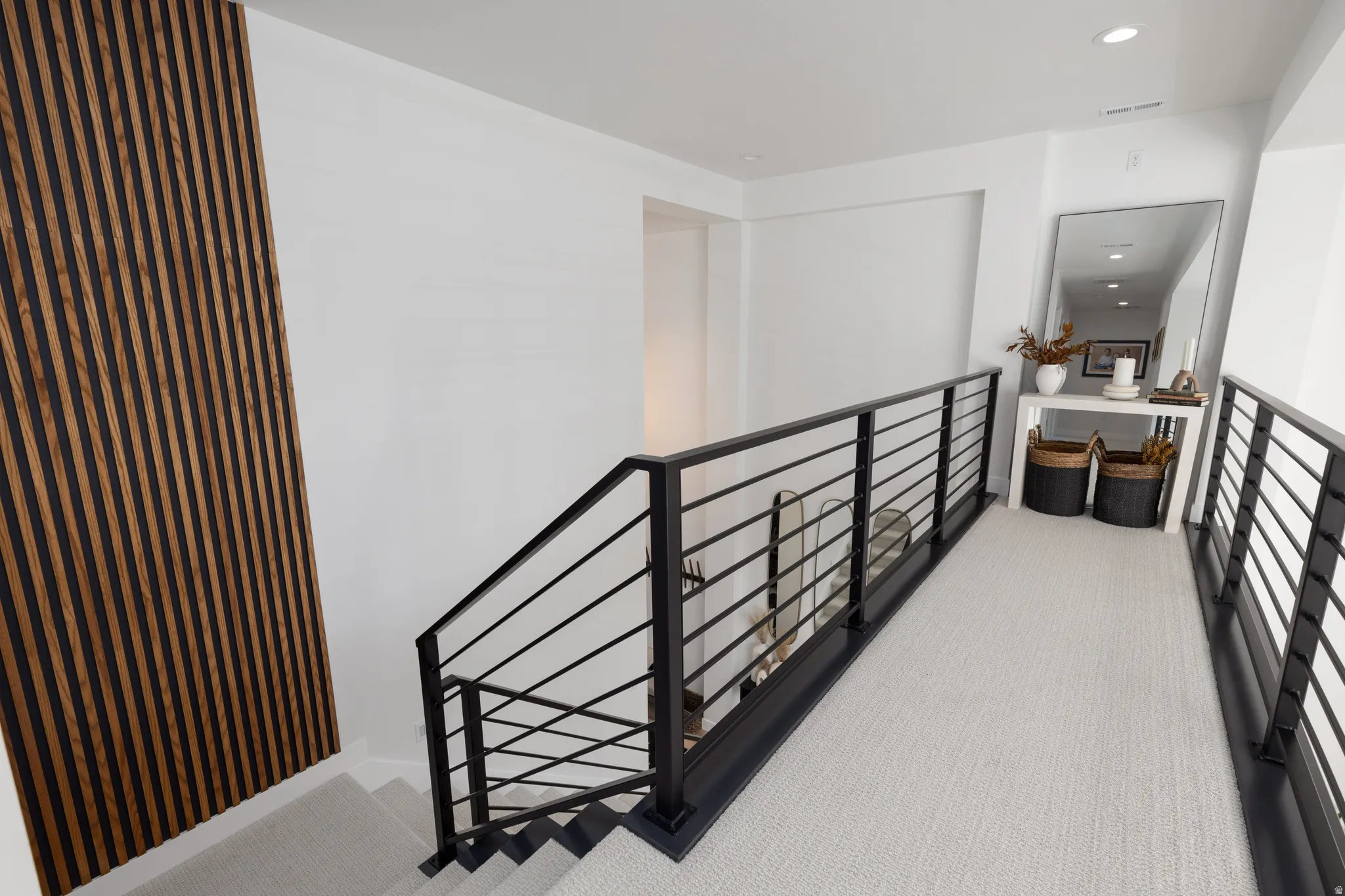 Corridor featuring carpet flooring, an upstairs landing, and recessed lighting
