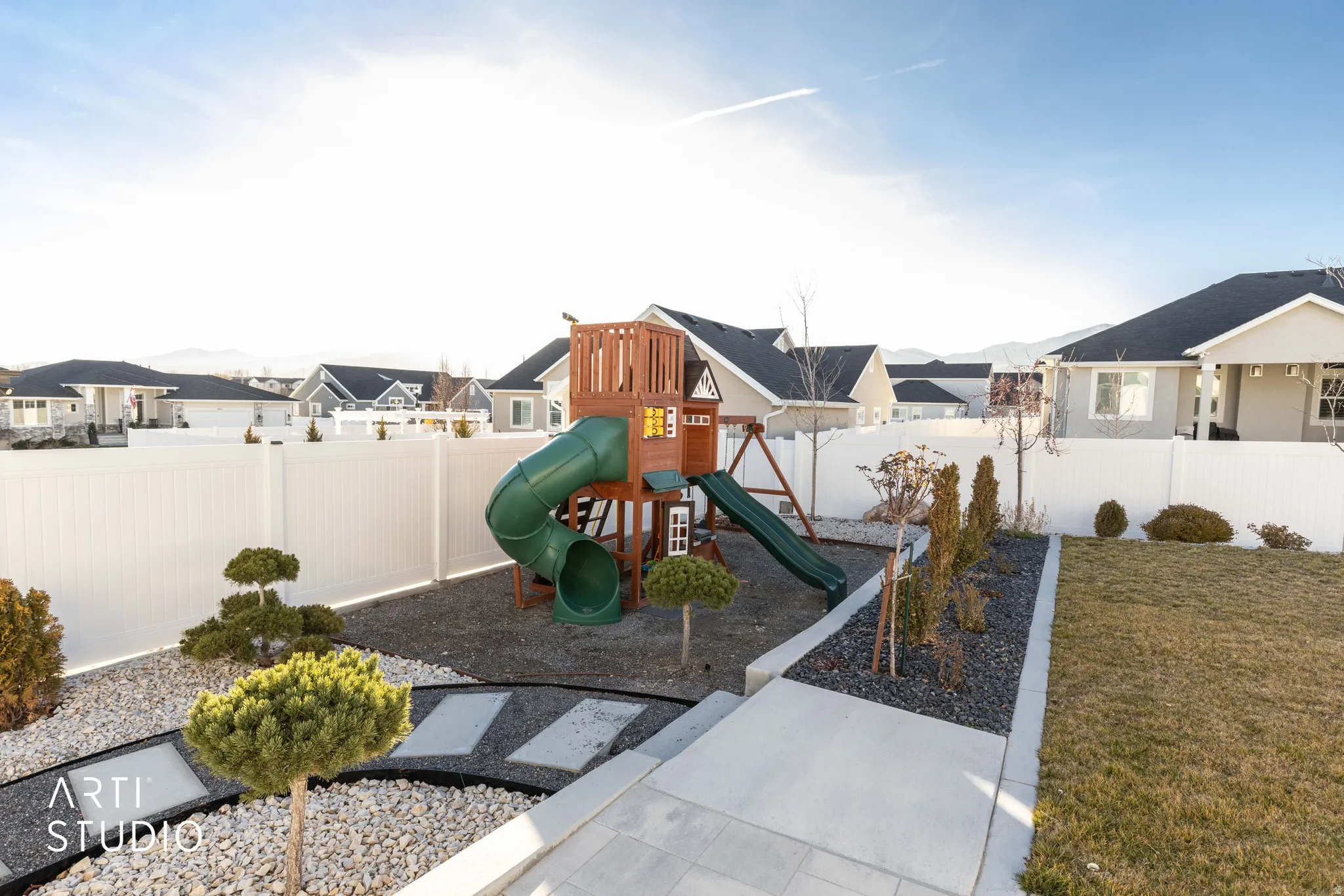 View of jungle gym featuring a fenced backyard and a residential view